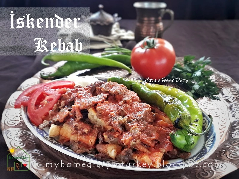 8 Najlepsze Kebaby w Warszawie - Gdzie Zjeść Prawdziwy Turecki Kebab ? Plate of homemade Iskender Kebab with grilled green peppers, tomato slices, and fresh herbs on a decorative tray.